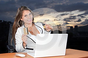 Online shopping Happy woman in the office using your credit card