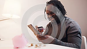 Online shopping, Happy young man using smartphone for online shopping and paying with credit card