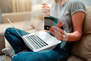 Online shopping at home. Hands are holding credit cards and using laptop before buying in an online shop