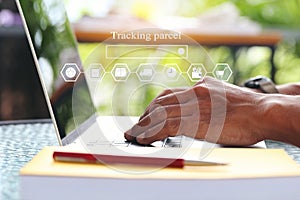 Online shopping, Man using laptop computer and tracking parcel online to update status with hologram, Ecommerce and delivery