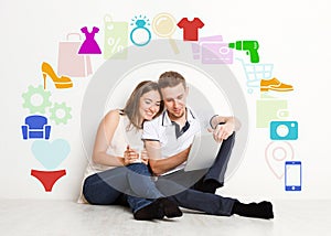 Online shopping. Millennial couple with tablet computer surrounded by different icons of household goods, collage
