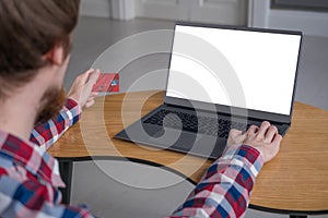 Online shopping mockup - man using laptop and holding credit card