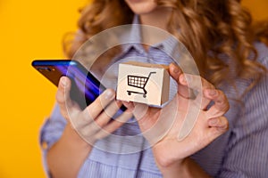 Online shopping. Paper boxes in woman`s hand and phone. Delivery service concept.