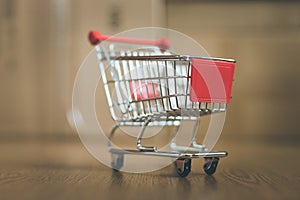 Concept of online shopping: Little shopping cart on delivery boxes