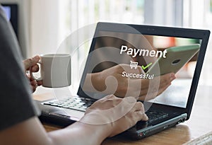 Online shopping and online payment concept. Man hands using laptop computer for online shopping at home, Hand holding coffee cup a