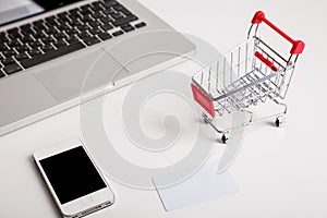 Online shopping. Shopping cart, keyboard, bank card