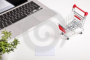 Online shopping. Shopping cart, keyboard, bank card