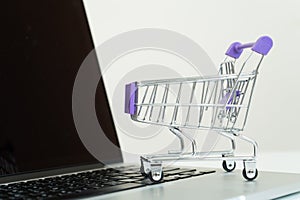 Online shopping, shopping cart on laptop.E-Commerce concept