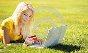 Online Shopping. Smiling Blonde Girl with Laptop