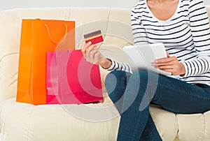 Online shopping. smiling young woman with tablet and credit card