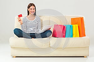 Online shopping. smiling young woman with tablet and credit card