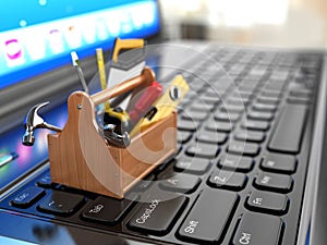 Online support. Toolbox with tools on laptop.
