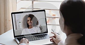 Online teacher or psychologist webcam conferencing with african school girl