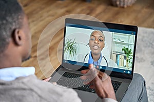 Online telehealth meeting of patient and doctor at home using laptop.