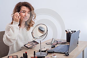 Online training for make-up. A woman teacher explains the makeup application scheme on the air