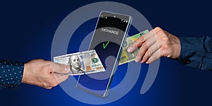 Online transfers, exchange, payment systems. Mobile banking. A hand puts dollars into a smartphone and takes out euros