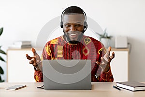 Online Tutoring. Male African Teacher In Headset Having Web Lesson With Laptop