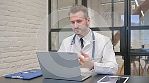 Online Video Chat by Middle Aged Doctor in Clinic