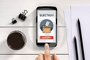 Online voting concept on smart phone screen with office objects