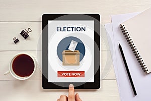 Online voting concept on tablet screen with office objects