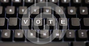 Online voting concept. Vote text written on keypad. Black keys with white letters message for election on pc keyboard. Blur