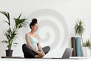 Online Yoga. Beautiful Young Woman Practicing Meditation With Laptop At Home