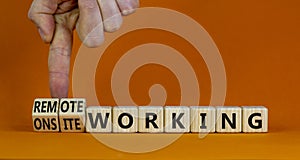 Onsite or remote working symbol. Businessman turns cubes and changes words `remote working` to `onsite working`. Beautiful ora