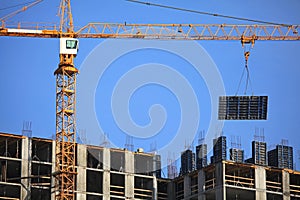 Ð¡onstruction crane with formwork shield at the construction of monolithic apartment building