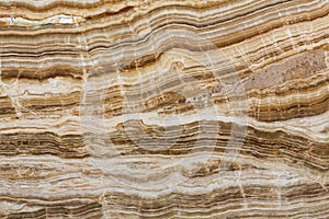 Onyx texture of natural stone, brown background.