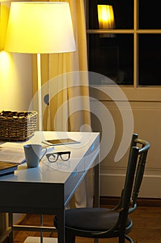 OObjects on the desk - Cup of hot drink, spectacles, books and tablet PC