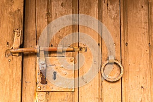 Ood old door with round metal knobs for exterior design. Antique and grunge style.