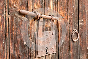 Ood old door with round metal knobs for exterior design. Antique and grunge style. Brown wooden surface door photography image.