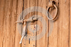 Ood old door with round metal knobs for exterior design. Antique and grunge style. Brown wooden surface door photography image.