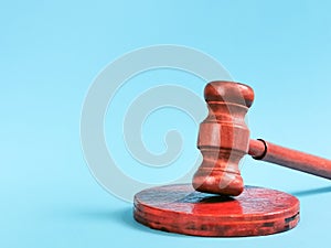 Ooden gavel isolated on blue background.