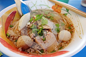Ooking, Pork noodles with fish ball,hot and sour soup photo