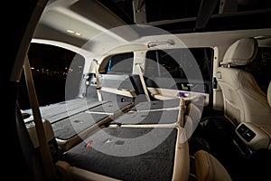 oomy empty interior of premium suv. rear seats folded in flat flor in luxury expencive suv car, side view of flat flor