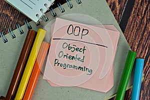 OOP - Object Oriented Programming write on sticky notes isolated on Wooden Table photo