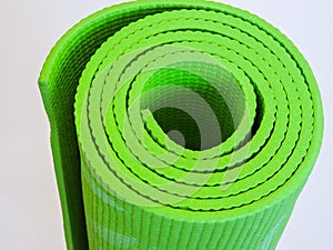 Op view green  yoga mat sport isolated.Rolled up yoga mat isolated on white. Copyspace.