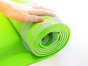 Op view green  yoga mat sport .Rolled up yoga mat isolated on white. Copyspace.