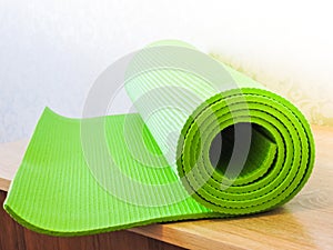 Op view green  yoga mat sport .Rolled up yoga mat isolated on white. Copyspace.