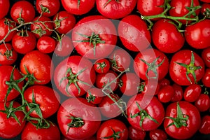 op view of ripe fresh tomatoes with water drops on black background