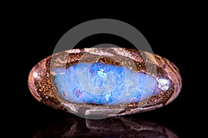 Opal between a bedrock, black background, mineral gemstone, heal