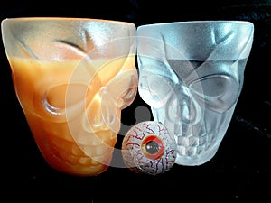 Opal skull glasses filled with pumpkin flavored liqueur and firewater