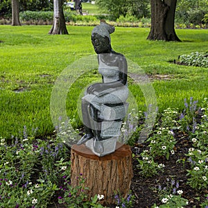 Opal stone sculpture titled Bookreader by Jonothan Mhondorohuma in the Fort Worth Botanic Garden.