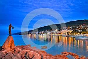 Opatija by night with girl with Seagull