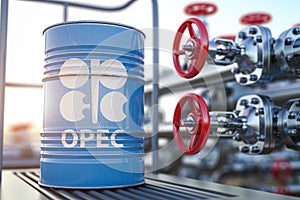 Opec symbol on the oil barrel and oil pipe line valve in front of the barrels
