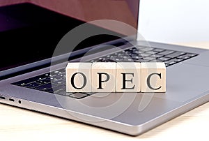 OPEC word on wooden block on laptop , business concept photo