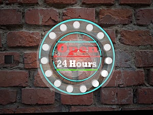 open 24 hours neon text sing on brick wall business background