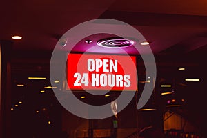 Open 24 hours sign banner in shop