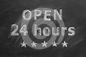 Open 24 hours written with chalk on blackboard